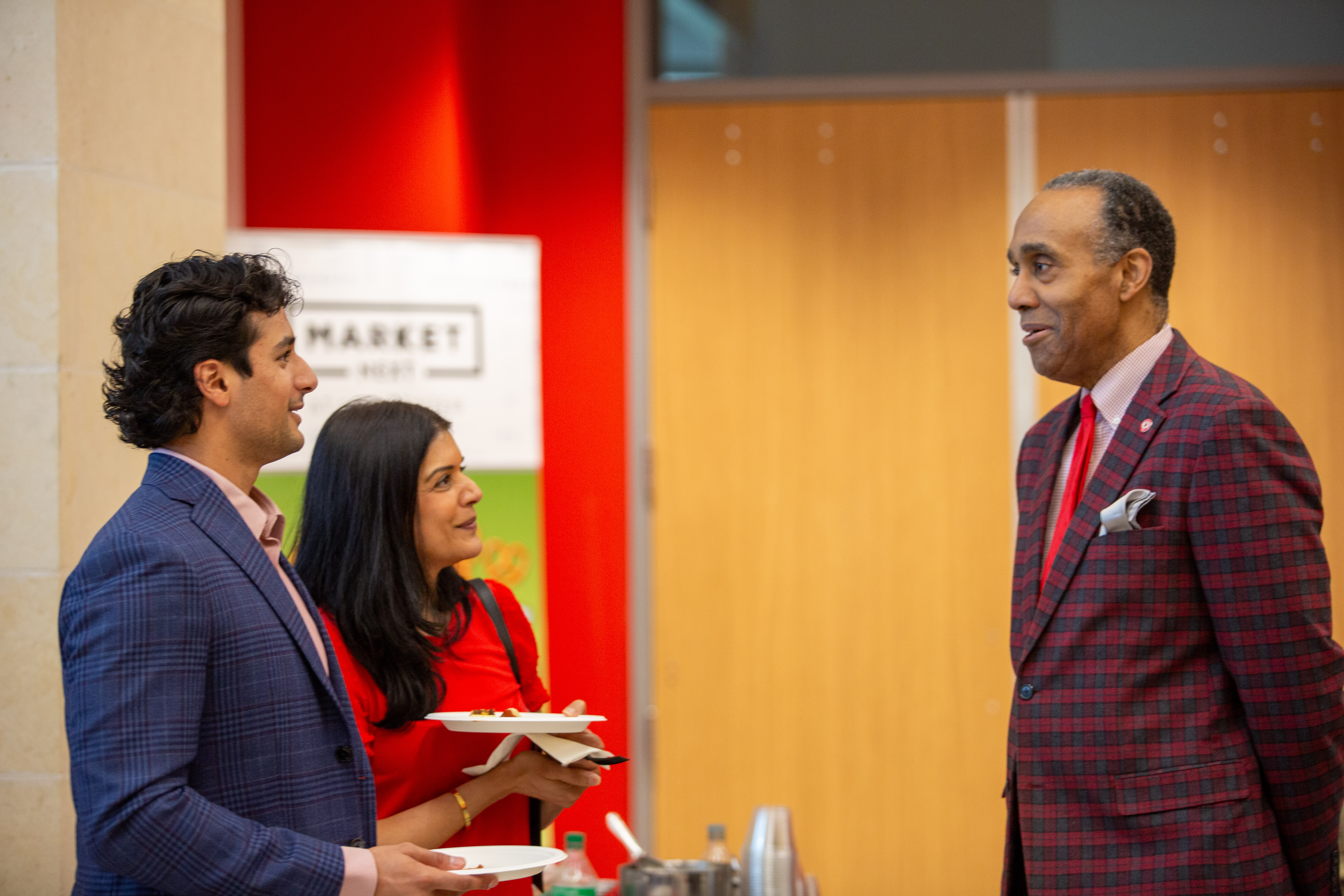 UH Law Dean Leonard M. Baynes speaks with two attendees during the 2026 Spring Admitted Students Day reception.